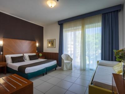 Modern room with double bed and balcony.